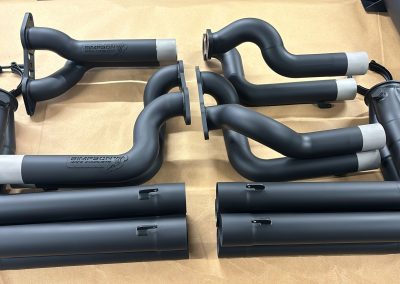 Ceramic coated exhaust pipes and silencers laid out after coating